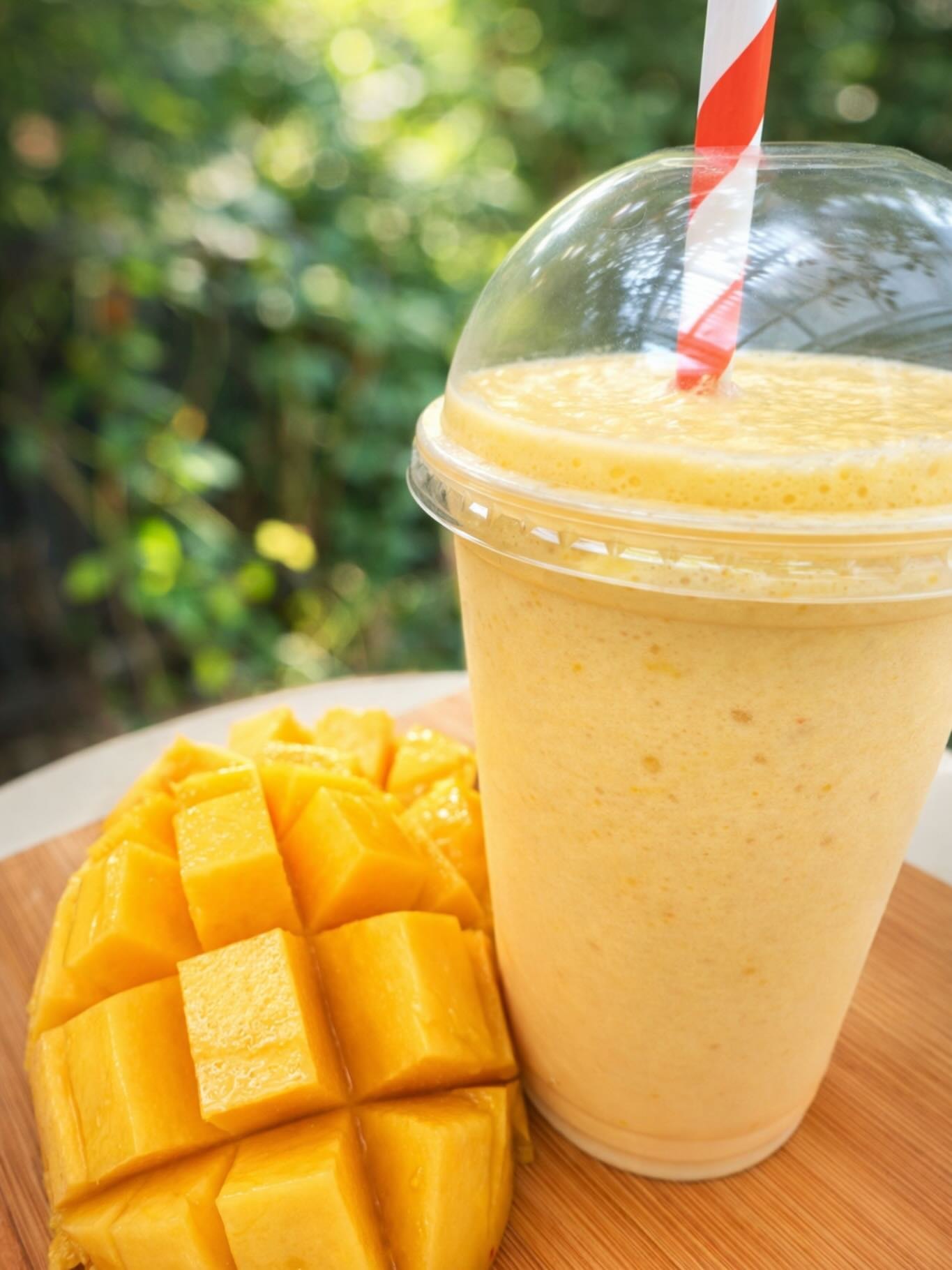 Mango smoothie with a striped straw
